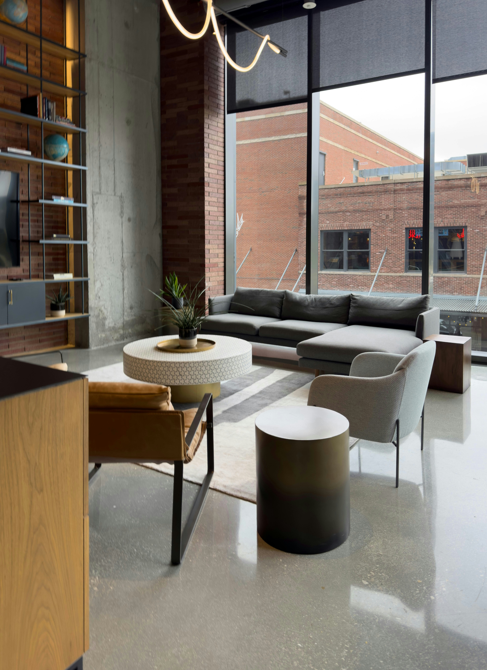 The living area at Ironmonger's Loft, showing the original cast-iron columns and factory windows